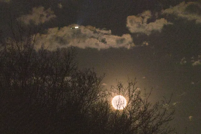 The "pink" super moon with plane